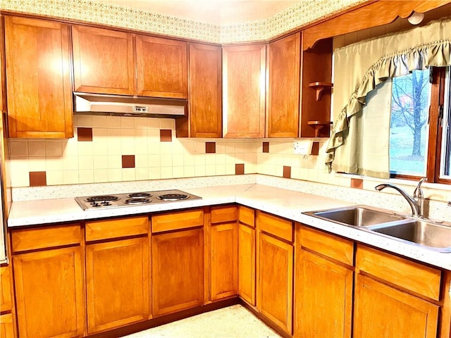 kitchen with tasteful backsplash, sink, and white stovetop