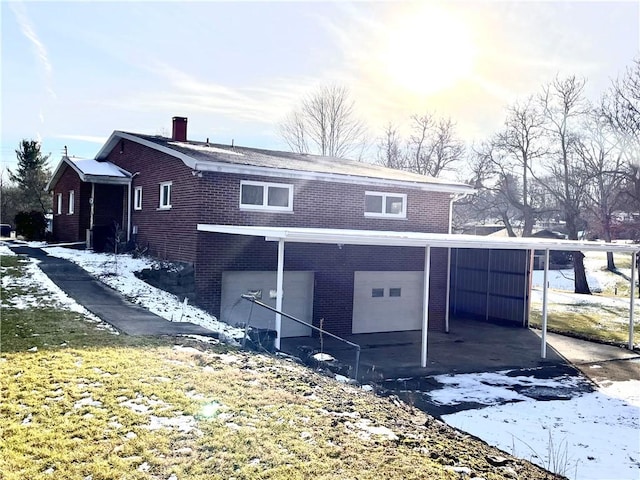 exterior space with a carport and a garage