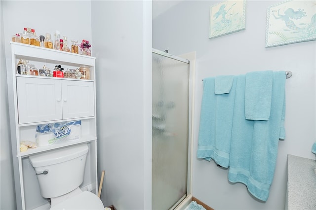 bathroom with toilet and an enclosed shower