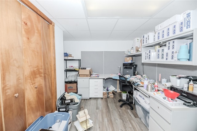 office space featuring light hardwood / wood-style flooring and a drop ceiling