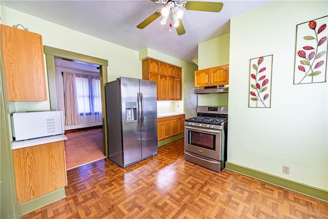 kitchen with ceiling fan, parquet floors, and appliances with stainless steel finishes