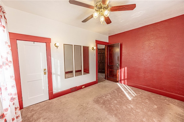 empty room with carpet flooring and ceiling fan