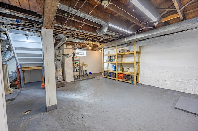 basement featuring water heater and sink