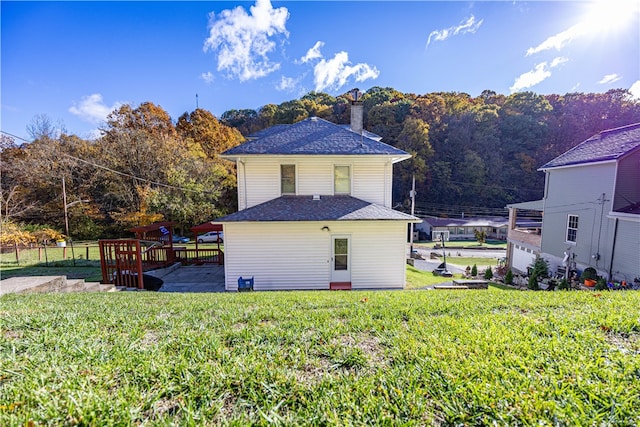 rear view of property featuring a yard