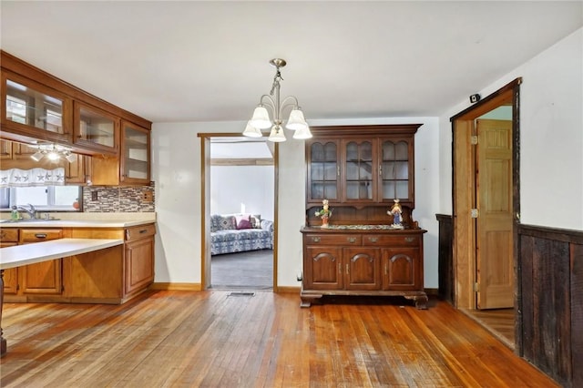 175 Long Woods Rd, Waynsbrg/Frankln Twp, PA 15370 - kitchen with a chandelier, light wood-type flooring, tasteful backsplash, and glass insert cabinets