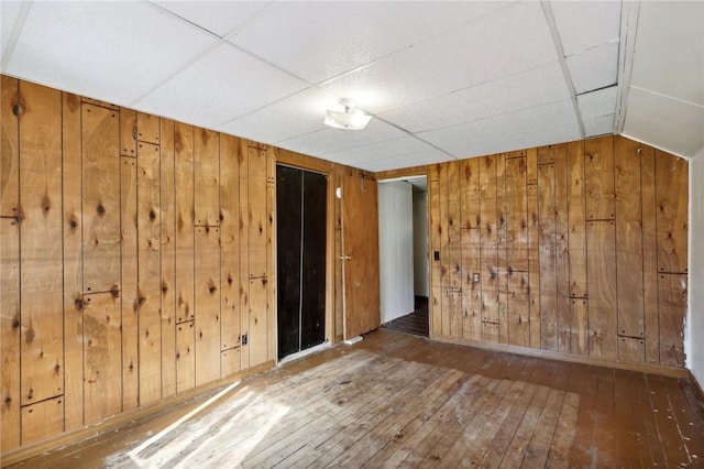 175 Long Woods Rd, Waynsbrg/Frankln Twp, PA 15370 - empty room featuring wooden walls, hardwood / wood-style floors, baseboards, and lofted ceiling