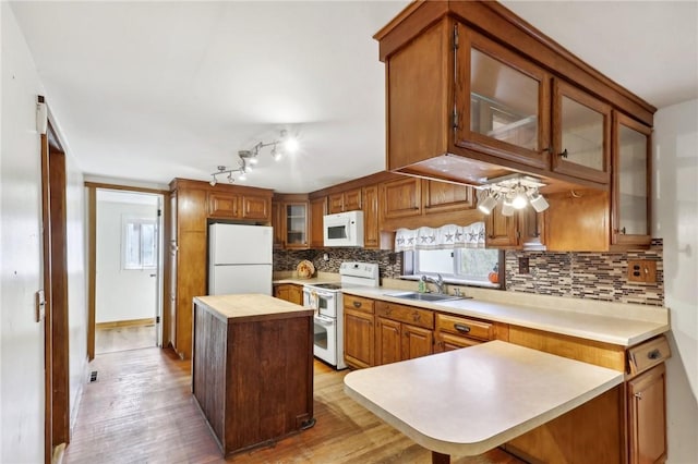 175 Long Woods Rd, Waynsbrg/Frankln Twp, PA 15370 - kitchen featuring white appliances, a sink, tasteful backsplash, light wood-type flooring, and a center island