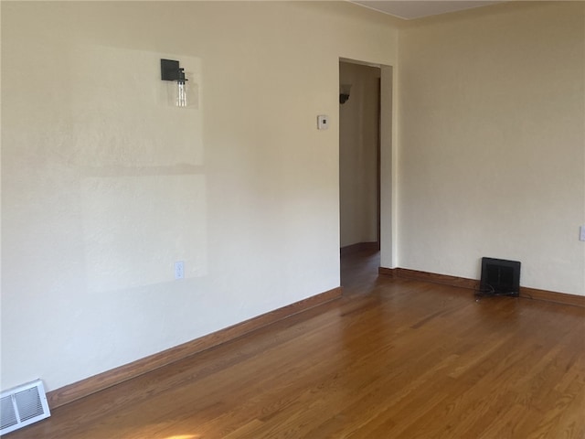 unfurnished room with hardwood / wood-style flooring