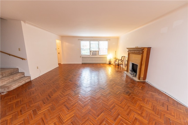 unfurnished living room with dark parquet flooring and radiator