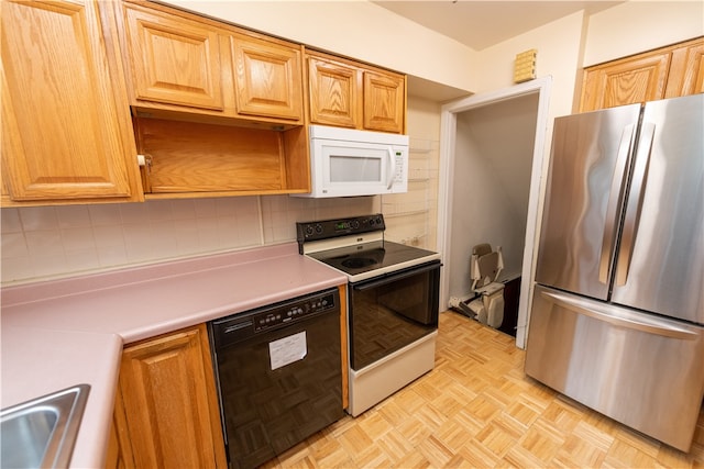 kitchen with tasteful backsplash, sink, light parquet flooring, and white appliances