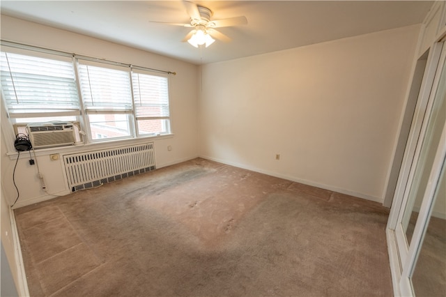 spare room featuring radiator, light carpet, cooling unit, and ceiling fan