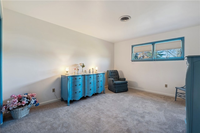 sitting room featuring light carpet