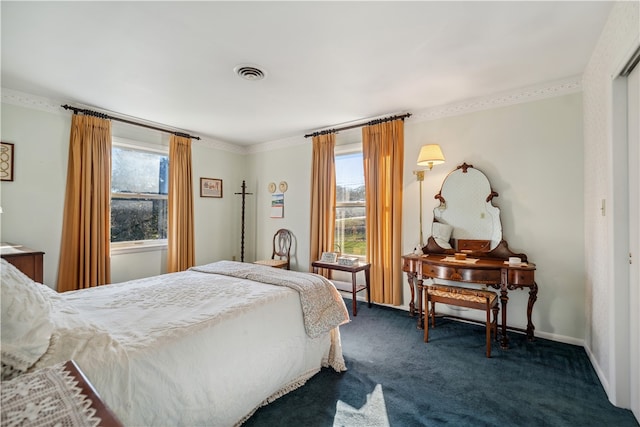 carpeted bedroom featuring multiple windows and ornamental molding