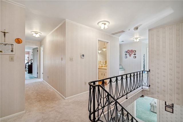 corridor with light colored carpet and ornamental molding