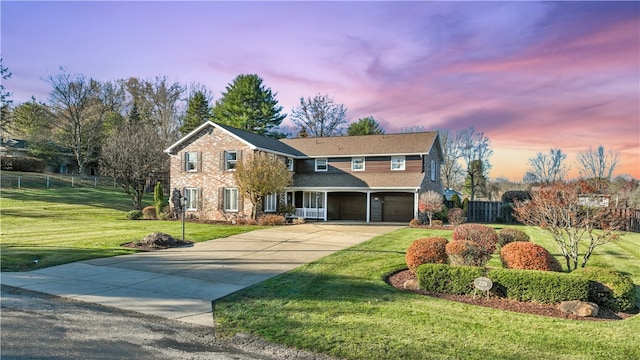 front facade with a yard and a garage