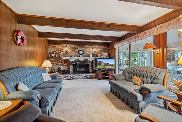 carpeted living room with wooden walls, a fireplace, and beamed ceiling