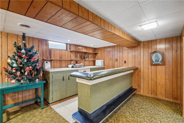 bar featuring wood walls and light carpet