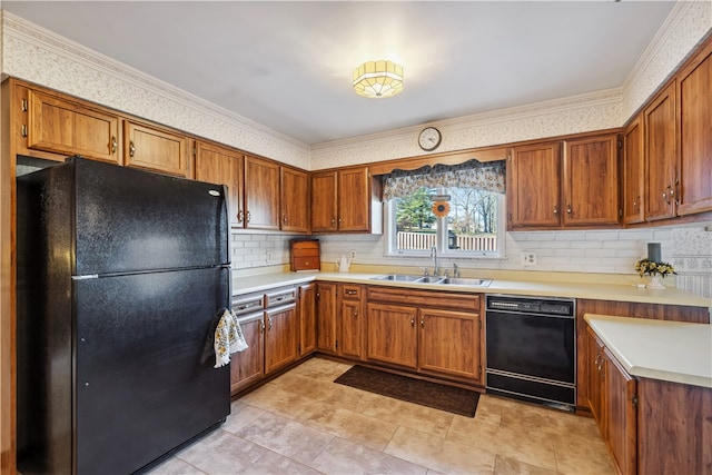 kitchen featuring tasteful backsplash, crown molding, sink, and black appliances