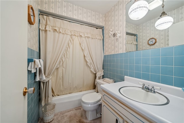 full bathroom with shower / bath combo, vanity, tile walls, and toilet