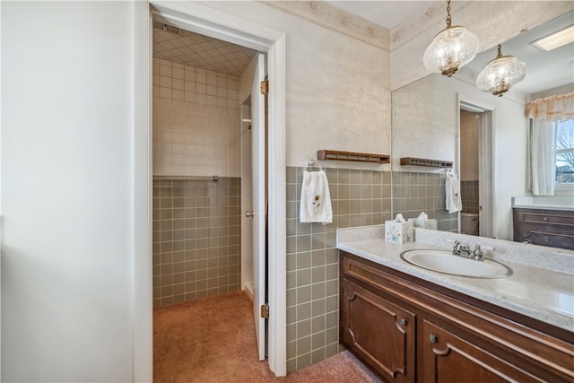 bathroom featuring vanity and tile walls