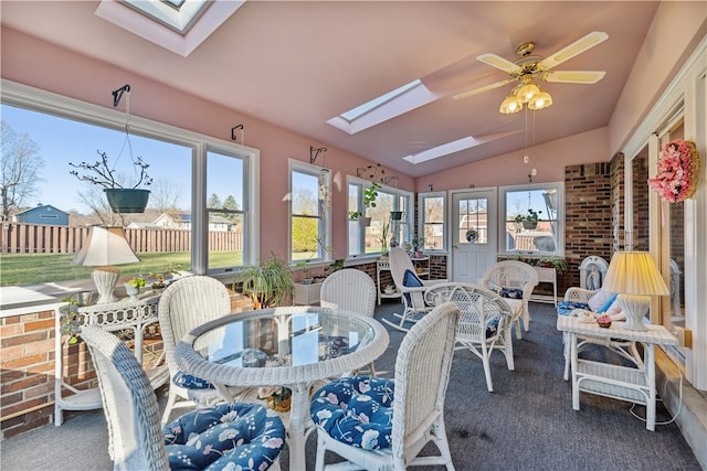 sunroom with lofted ceiling with skylight and ceiling fan