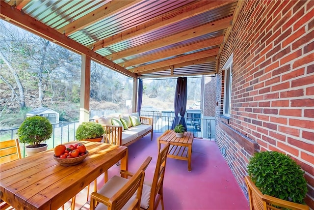 sunroom / solarium featuring beam ceiling