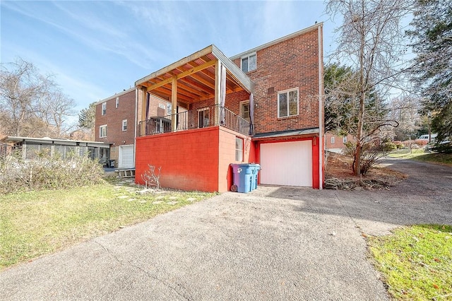 view of property exterior with a balcony and a garage