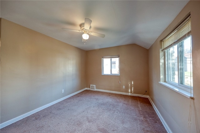 carpeted empty room with ceiling fan and vaulted ceiling