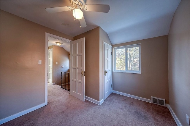 unfurnished bedroom featuring light colored carpet, ceiling fan, and lofted ceiling