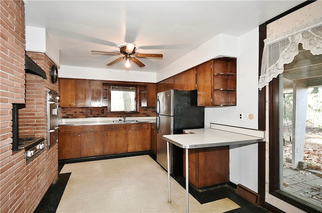 kitchen featuring decorative backsplash, appliances with stainless steel finishes, plenty of natural light, and sink