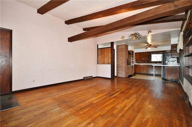 unfurnished living room with ceiling fan, lofted ceiling with beams, and dark hardwood / wood-style flooring