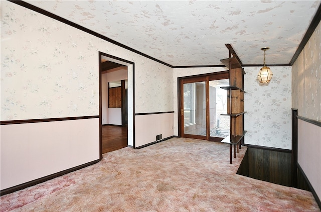 carpeted empty room with a textured ceiling, lofted ceiling, and crown molding