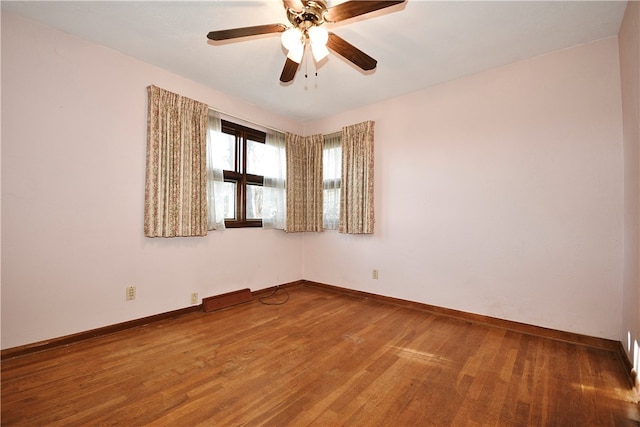 unfurnished room with ceiling fan and wood-type flooring