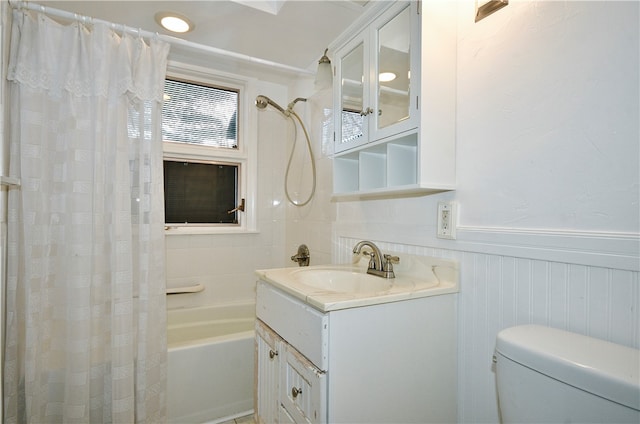 full bathroom featuring shower / bath combo, toilet, and vanity