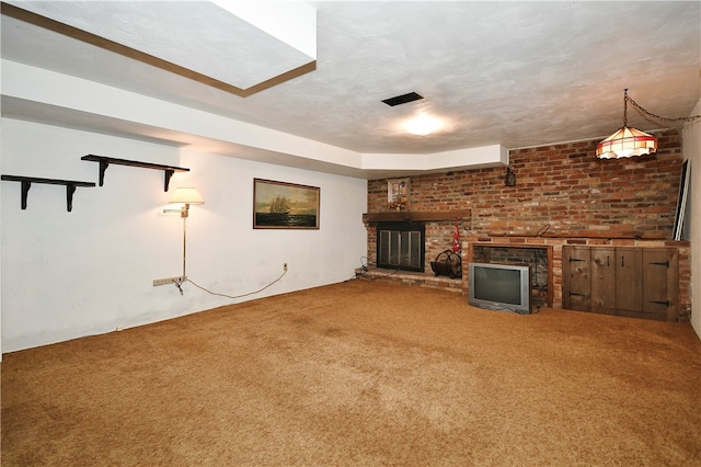 unfurnished living room with carpet floors and a brick fireplace