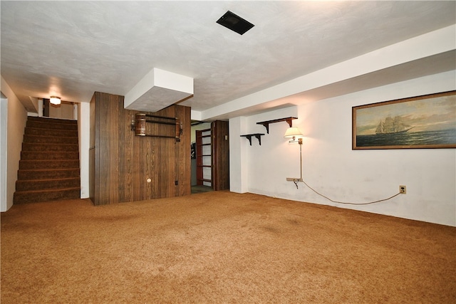 unfurnished living room with carpet and a textured ceiling