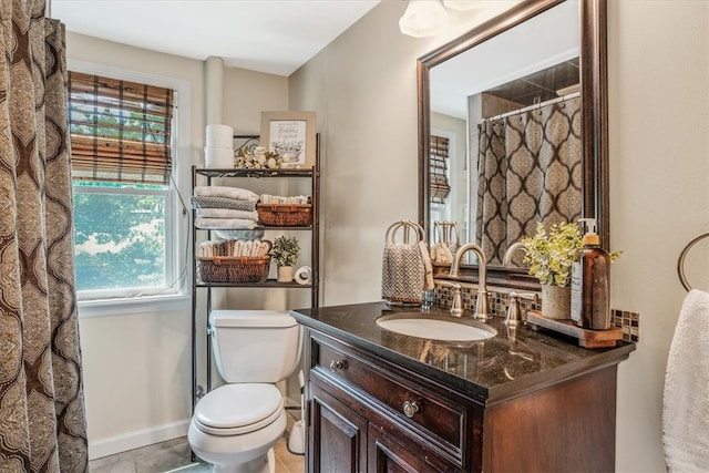 bathroom featuring tile patterned flooring, vanity, and toilet