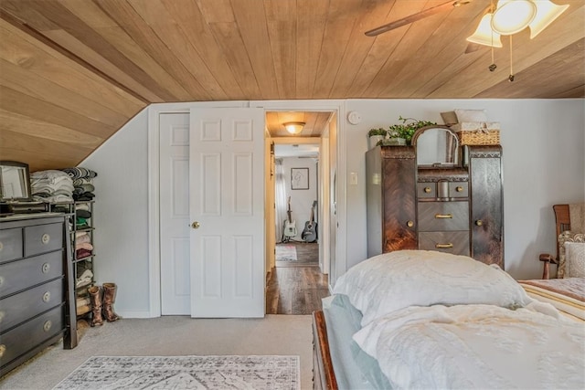 bedroom with hardwood / wood-style flooring, vaulted ceiling, ceiling fan, and wood ceiling