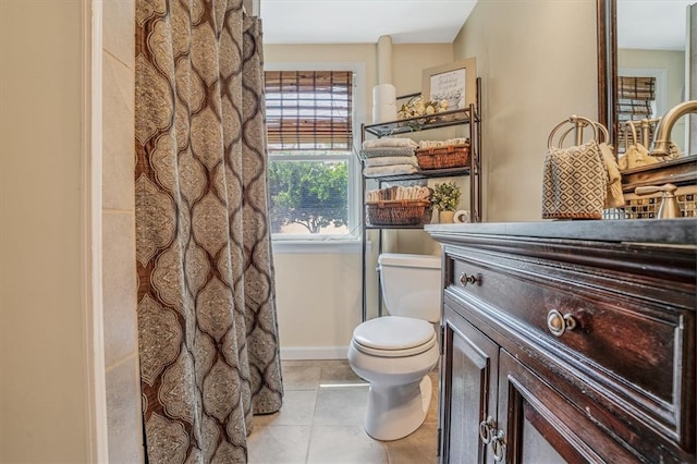 bathroom with tile patterned flooring, vanity, and toilet