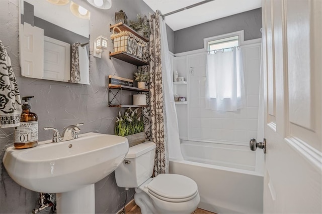 full bathroom with sink, shower / tub combo, and toilet