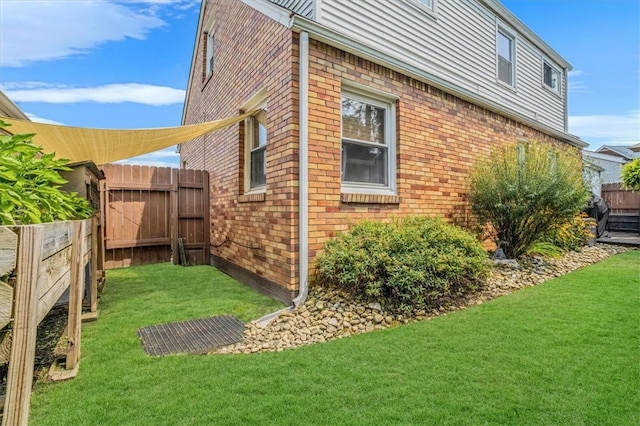 view of side of property with a yard