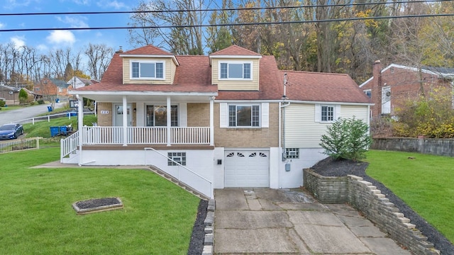 view of front of home with a front lawn, covered porch, and a garage