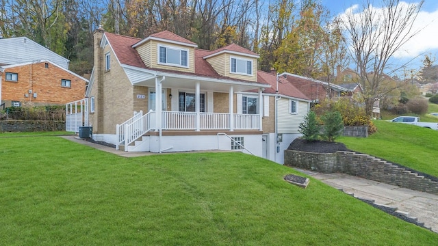 view of front of home with central AC, a front lawn, and a porch