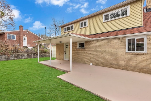 back of property featuring a yard and a patio