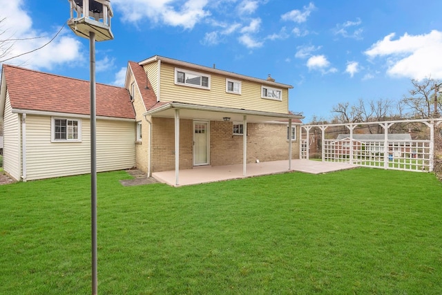 back of property featuring a patio area and a lawn