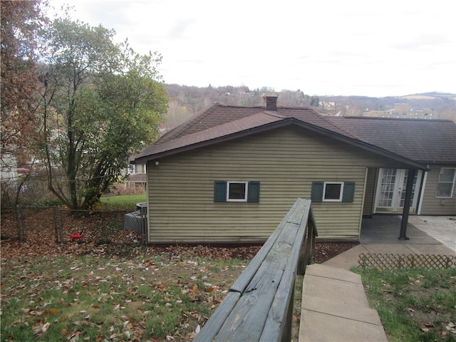 view of side of home with a patio area