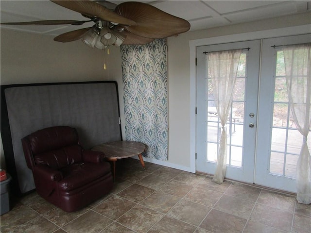 sitting room featuring french doors, a paneled ceiling, tile patterned floors, and ceiling fan