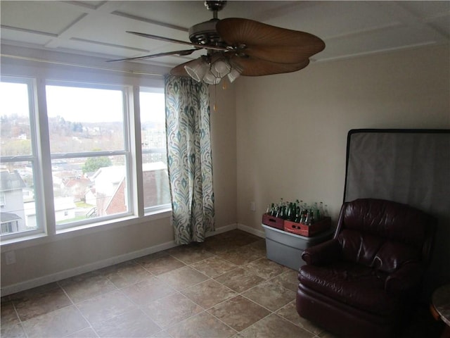 living area featuring tile patterned flooring, ceiling fan, and a wealth of natural light