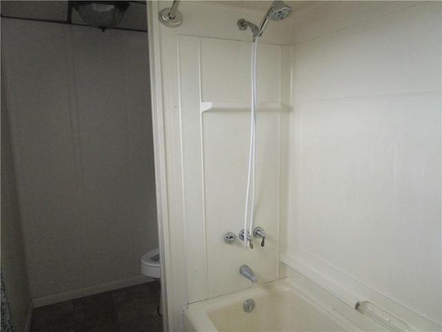 bathroom featuring toilet and washtub / shower combination