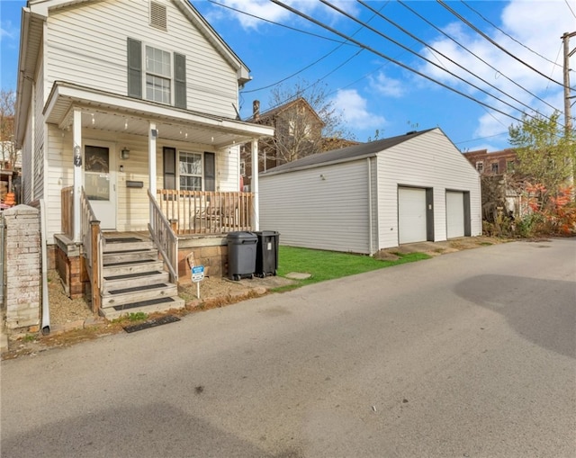 view of front of house with a porch, an outdoor structure, and a garage